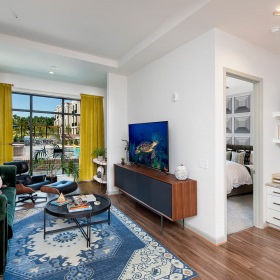 Model Living Area at Ten45 Suwanee, GA 30024 spacious living area with larde windows and ample space for couches and relaxation