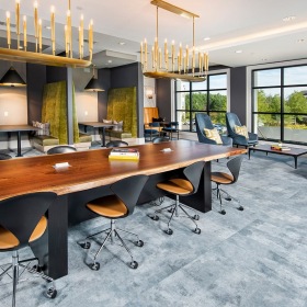 Cyber Cafe at Ten45 Suwanee, GA 30024 spacious cyber cafe with ample shared seating, a large shared table, & modern decor