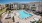 aerial view of swimming pool with modern tile-work and ample seating